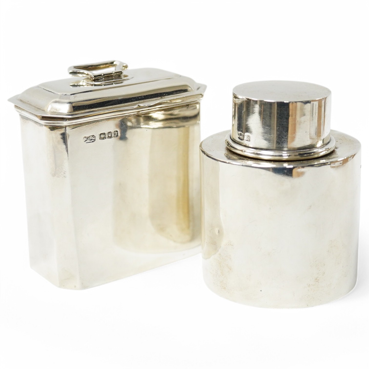 A George V silver octagonal tea caddy, by Carrington & Co, London, 1917, height 9cm, together with an earlier silver circular tea caddy, Birmingham, 1909, 9oz. Condition - fair and good